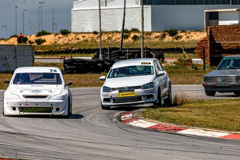 Three saloon cars battle through a tight hairpin at Aldo Scribante Raceway, Port Elizabeth