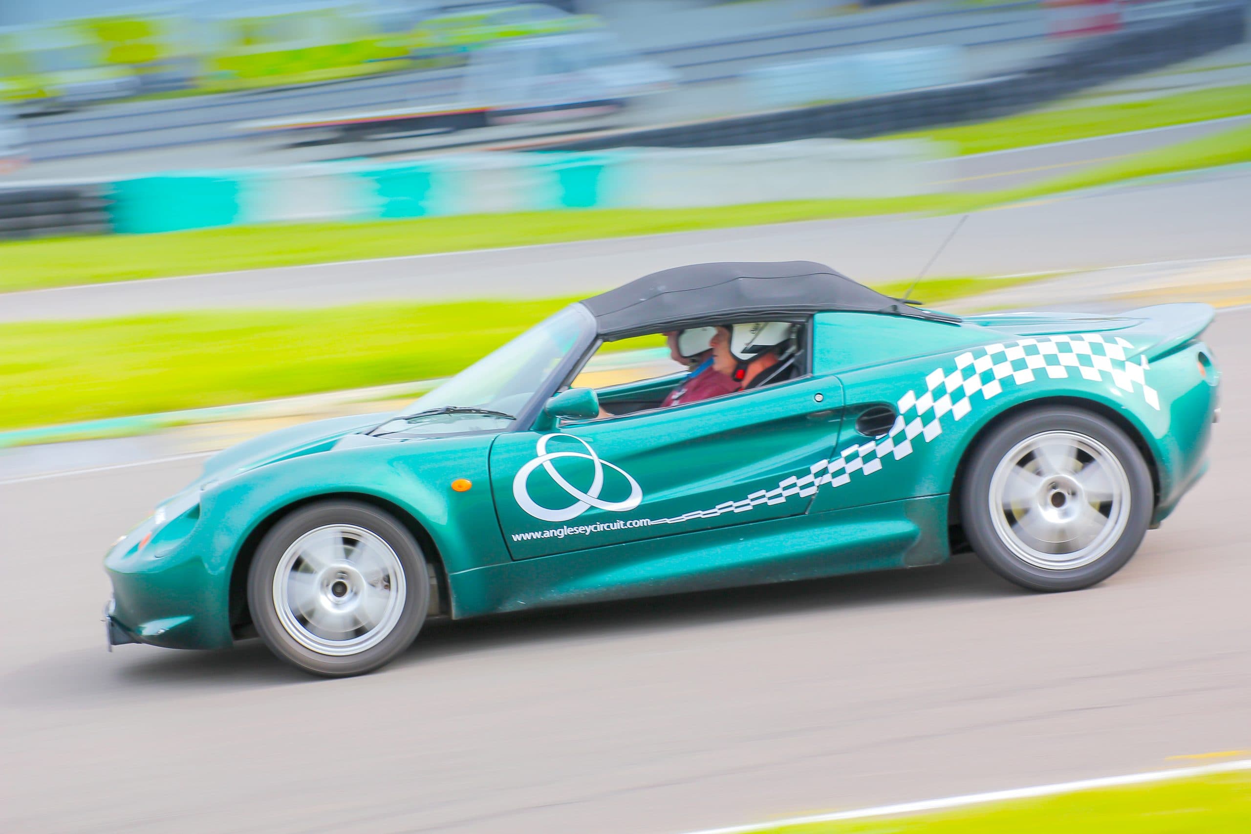 Teal Lotus Elise with Anglesey Circuit branding at speed on the Trac Mon circuit, Wales