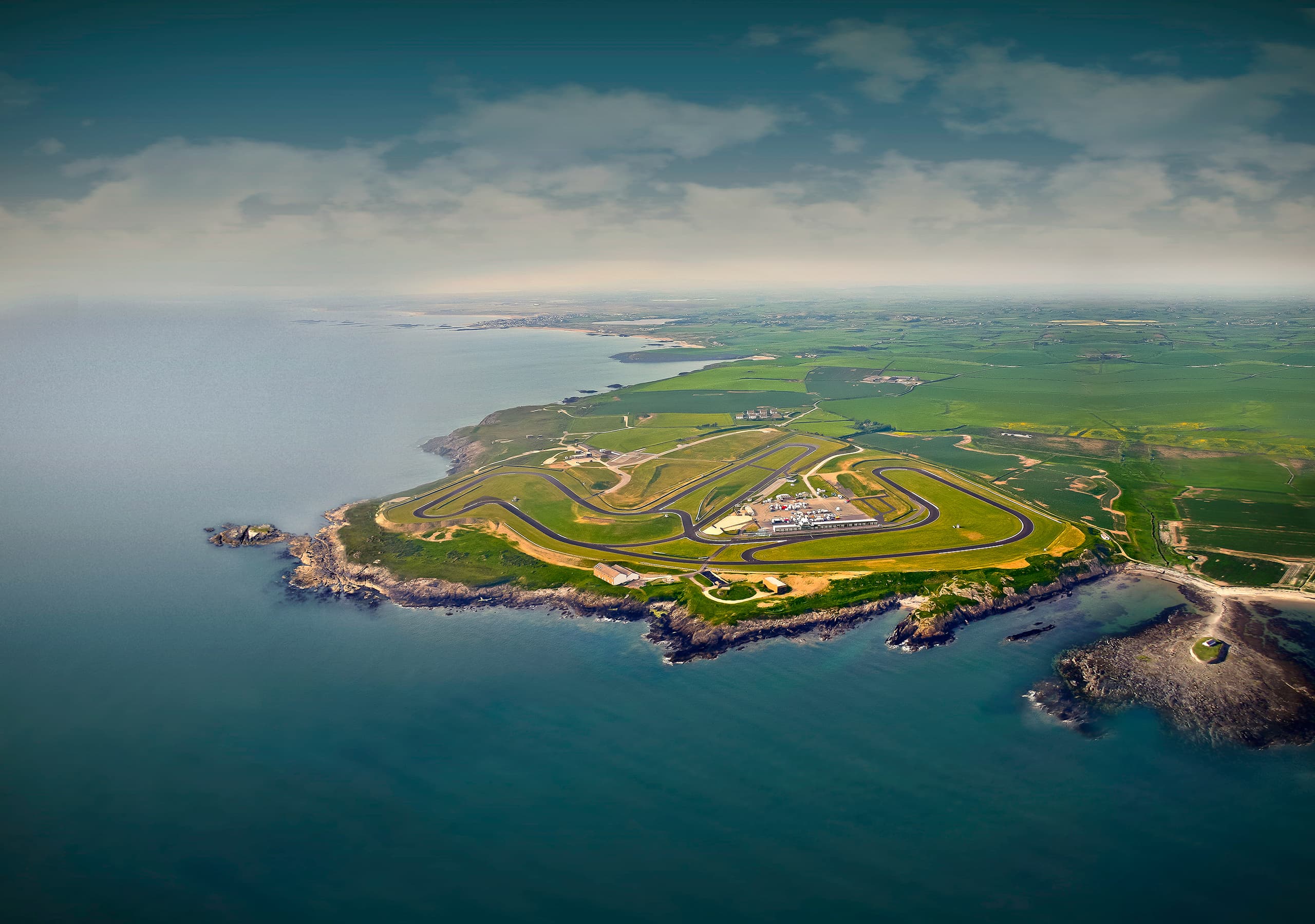 Aerial view of Anglesey Circuit on a rocky coastal headland, full circuit layout visible with Irish Sea on three sides
