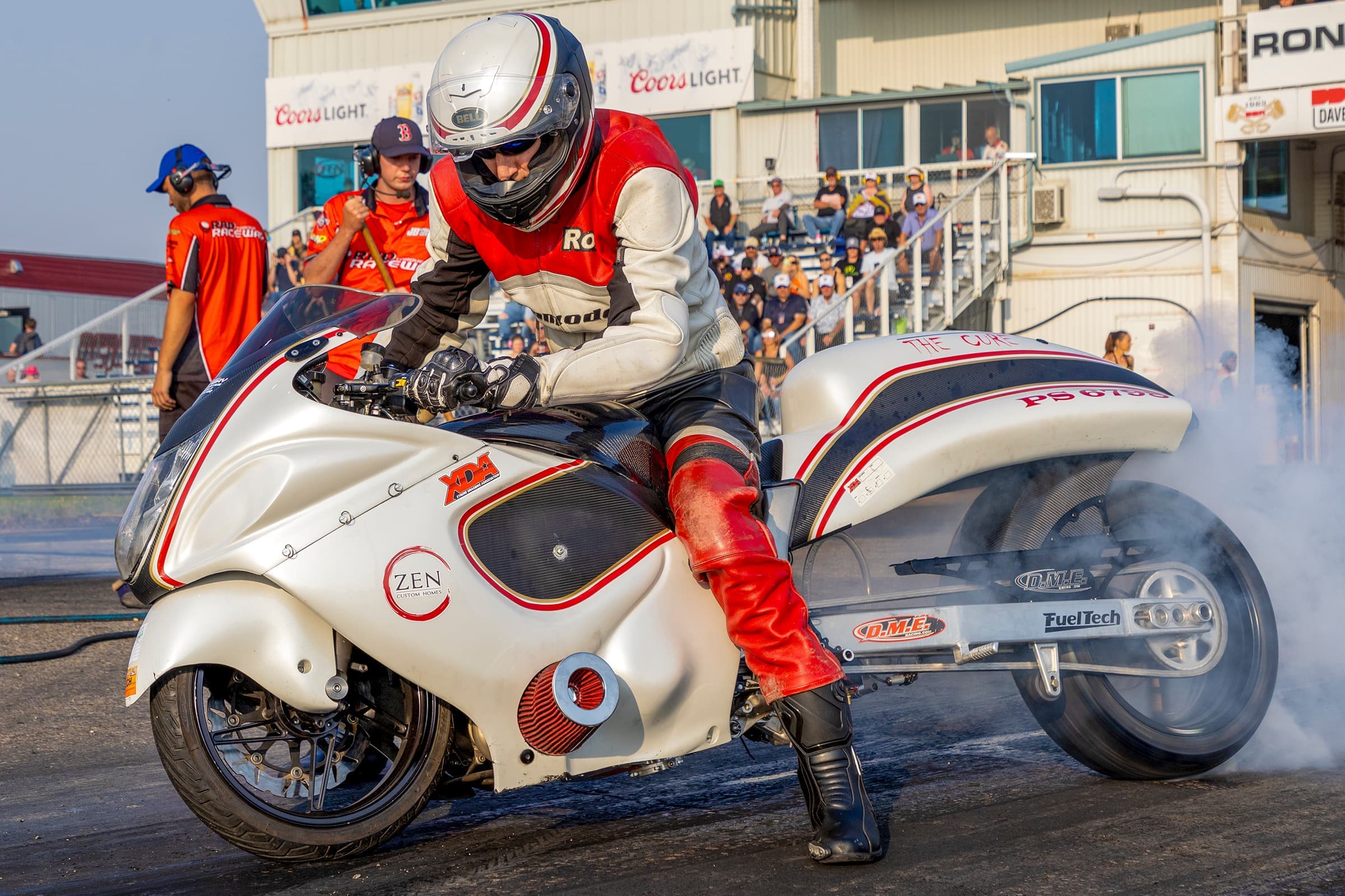 A drag racing motorcycle does a smoky burnout before the starting line at RAD Torque Raceway