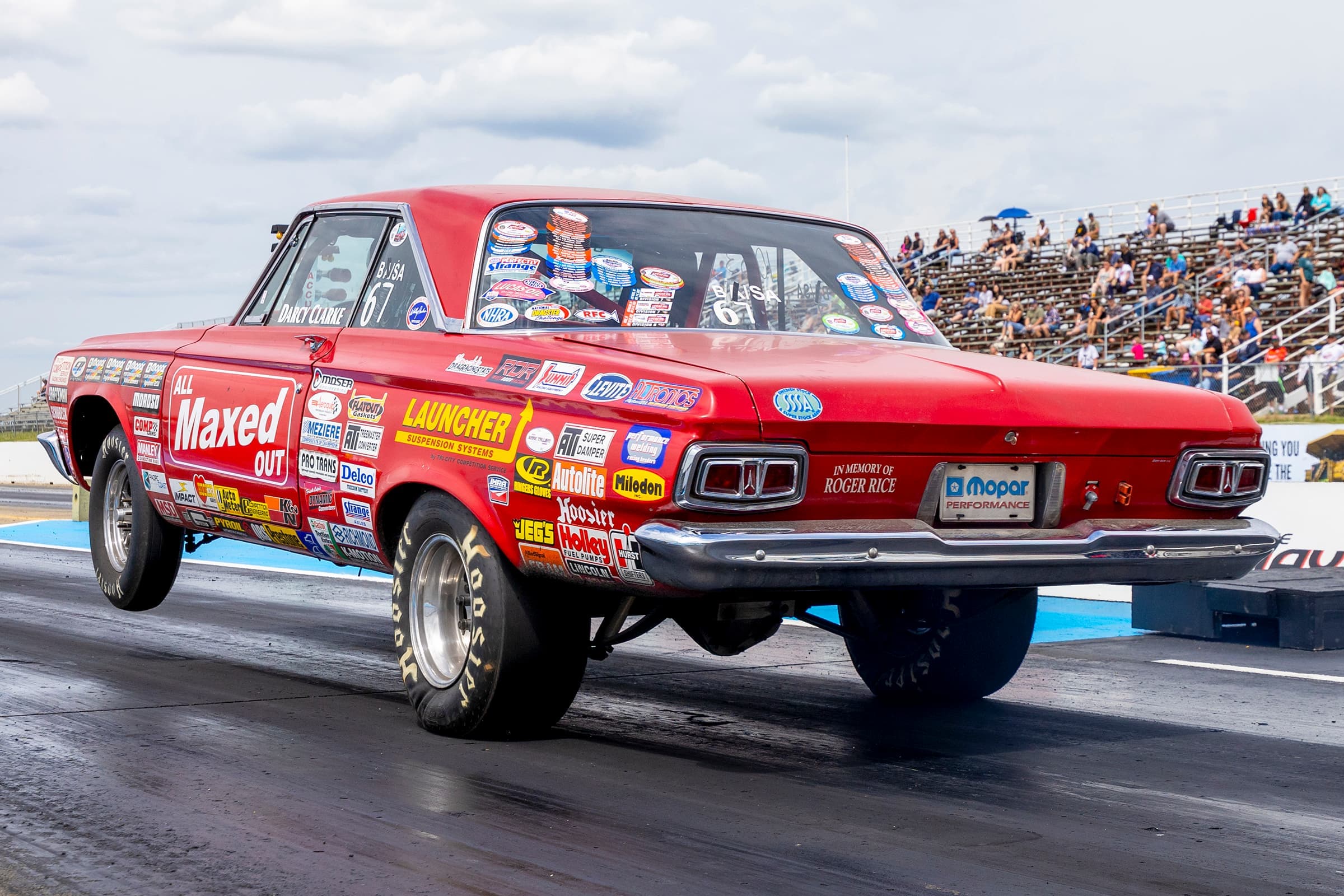 A vintage Plymouth Super Stock drag car pops a wheelstand off the line at RAD Torque Raceway