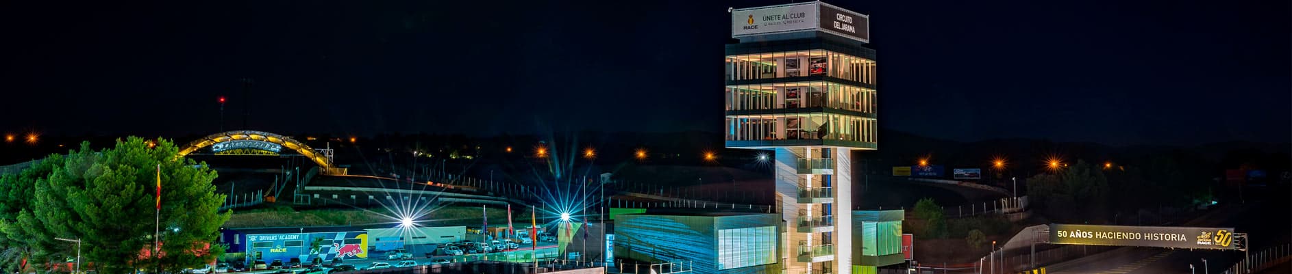 Night panorama of Circuito del Jarama RACE facilities and illuminated control tower near Madrid, Spain