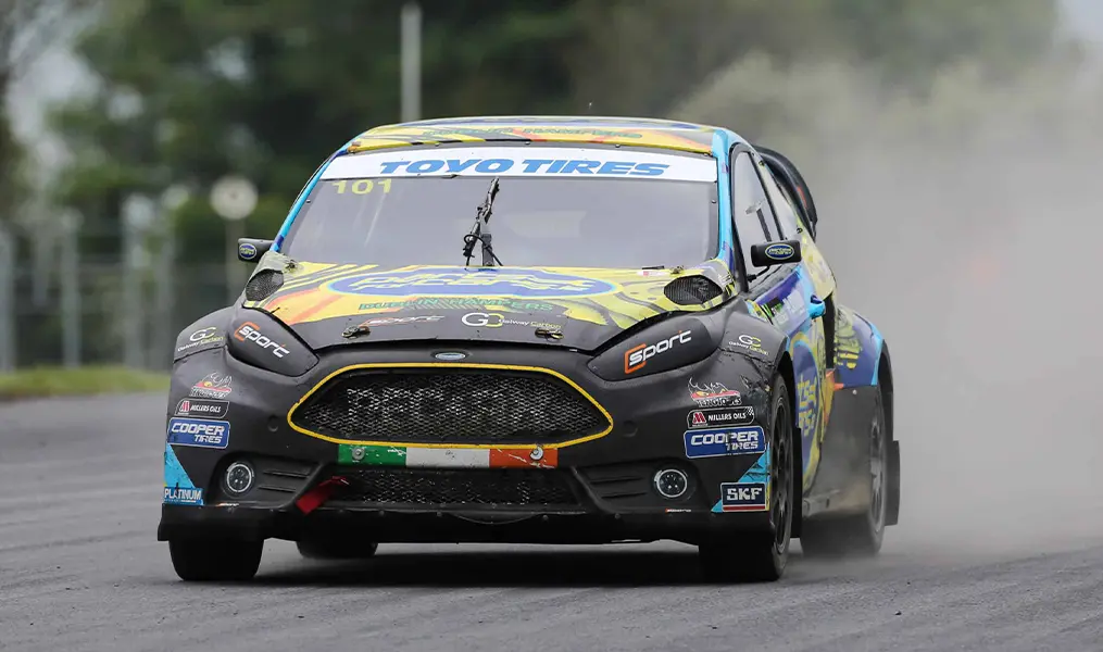 Rallycross Ford Fiesta kicking up dust accelerating down the straight at Mondello Park