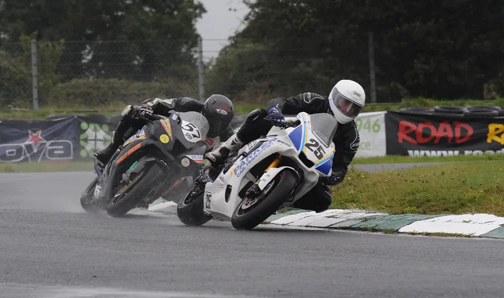 Two superbikes leaning through a wet corner at Mondello Park in County Kildare
