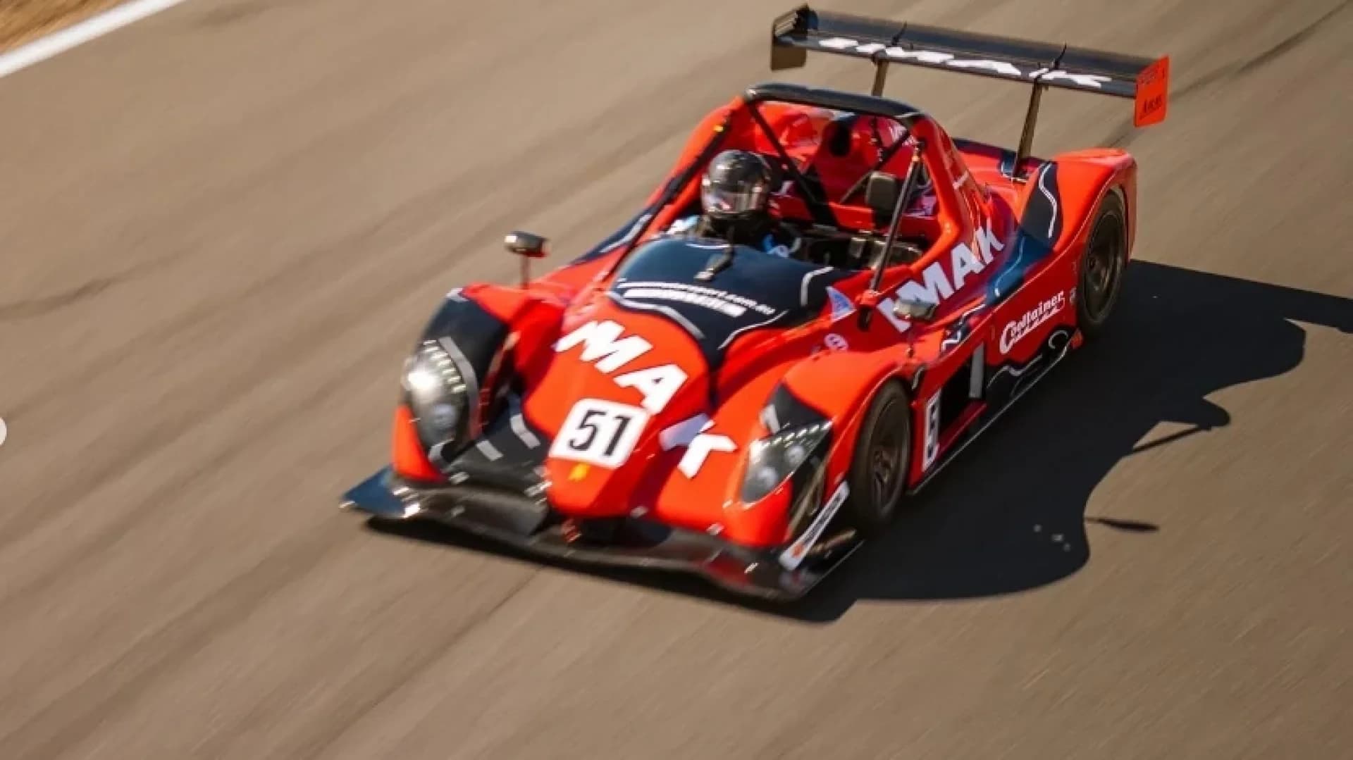 Red prototype sports car number 51 at speed on the circuit at Morgan Park Raceway, Warwick