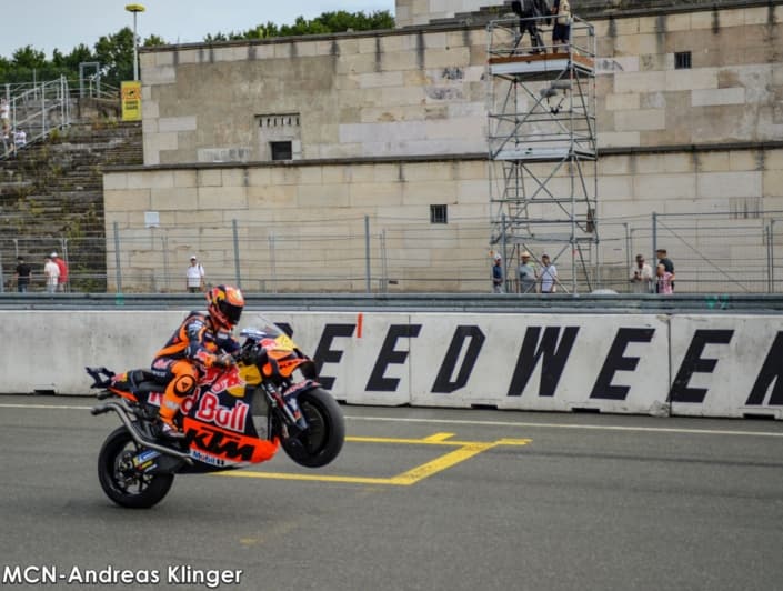 Motorcyclist popping a wheelie past the Zeppelin grandstand during Norisring Speedweekend in Nuremberg