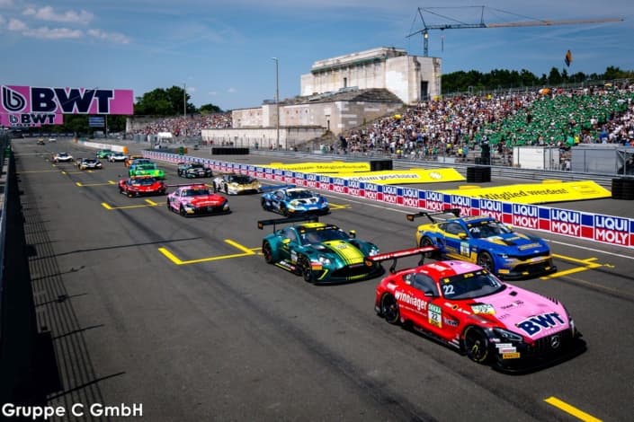 Grid of GT racecars lined up on the front straight before the Zeppelin grandstand at Norisring, Nuremberg